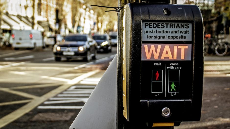 Pedestrian crossing signal in London indicating to wait for crossing safely.